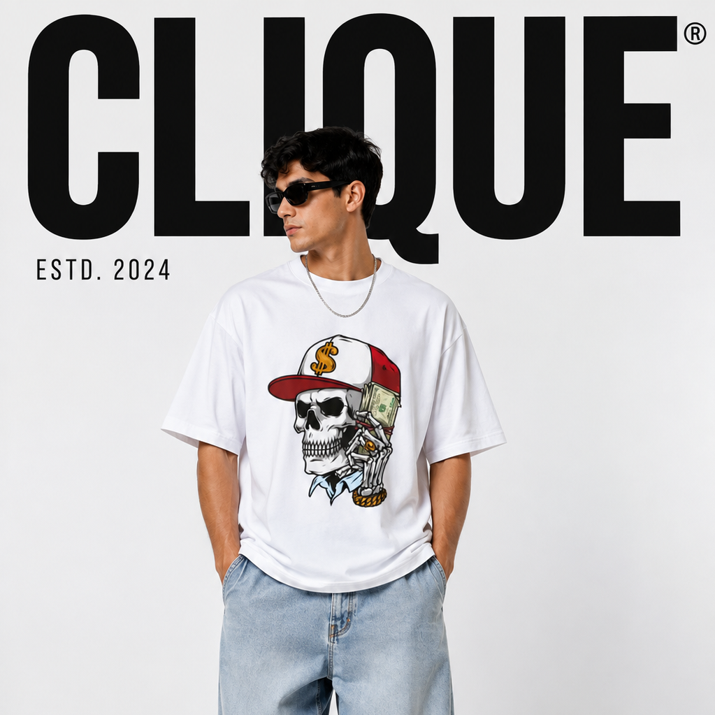 A man modeling a white graphic t-shirt featuring a skull wearing a red and gold baseball cap, paired with light-wash jeans and white sneakers. The image has a white background with a large black 'CLIQUE' logo at the top.