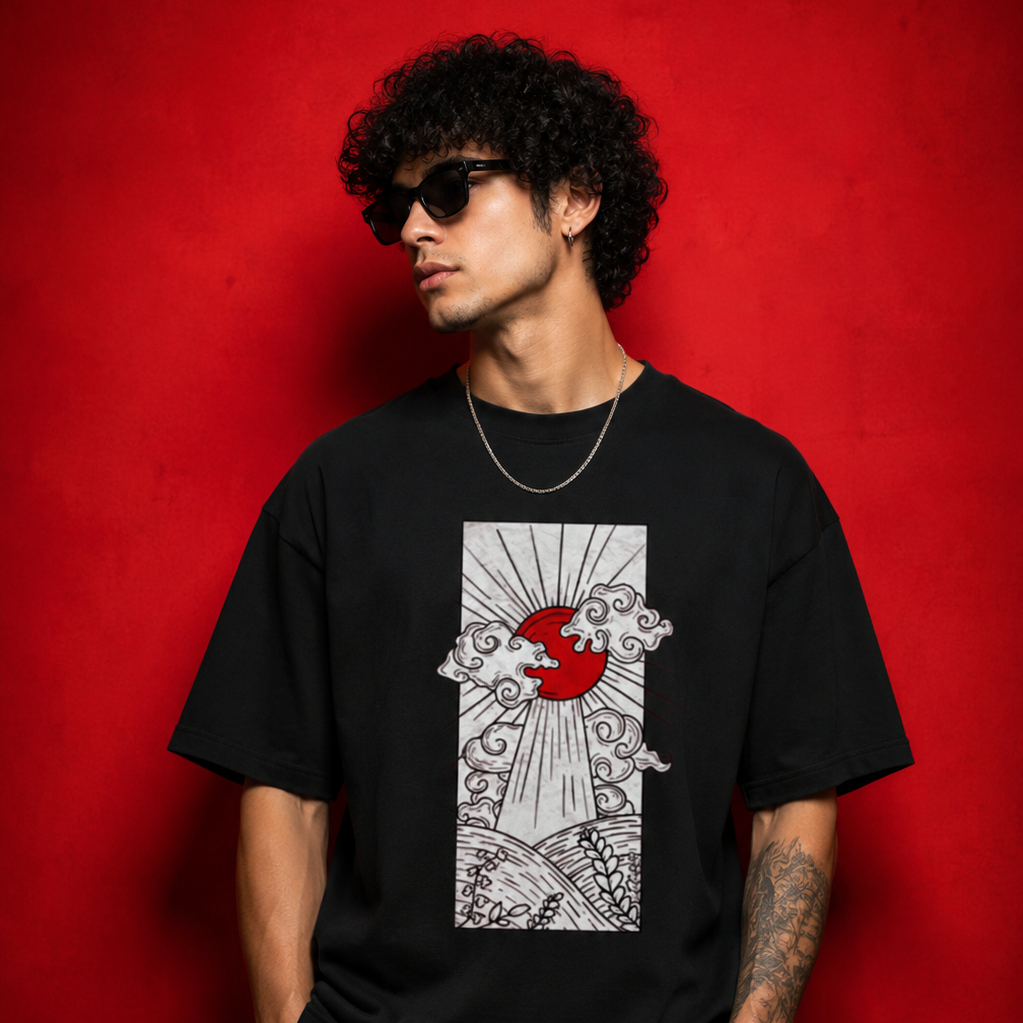 A man wearing a black graphic t-shirt with a red and white sunburst design, posed against a textured red background.